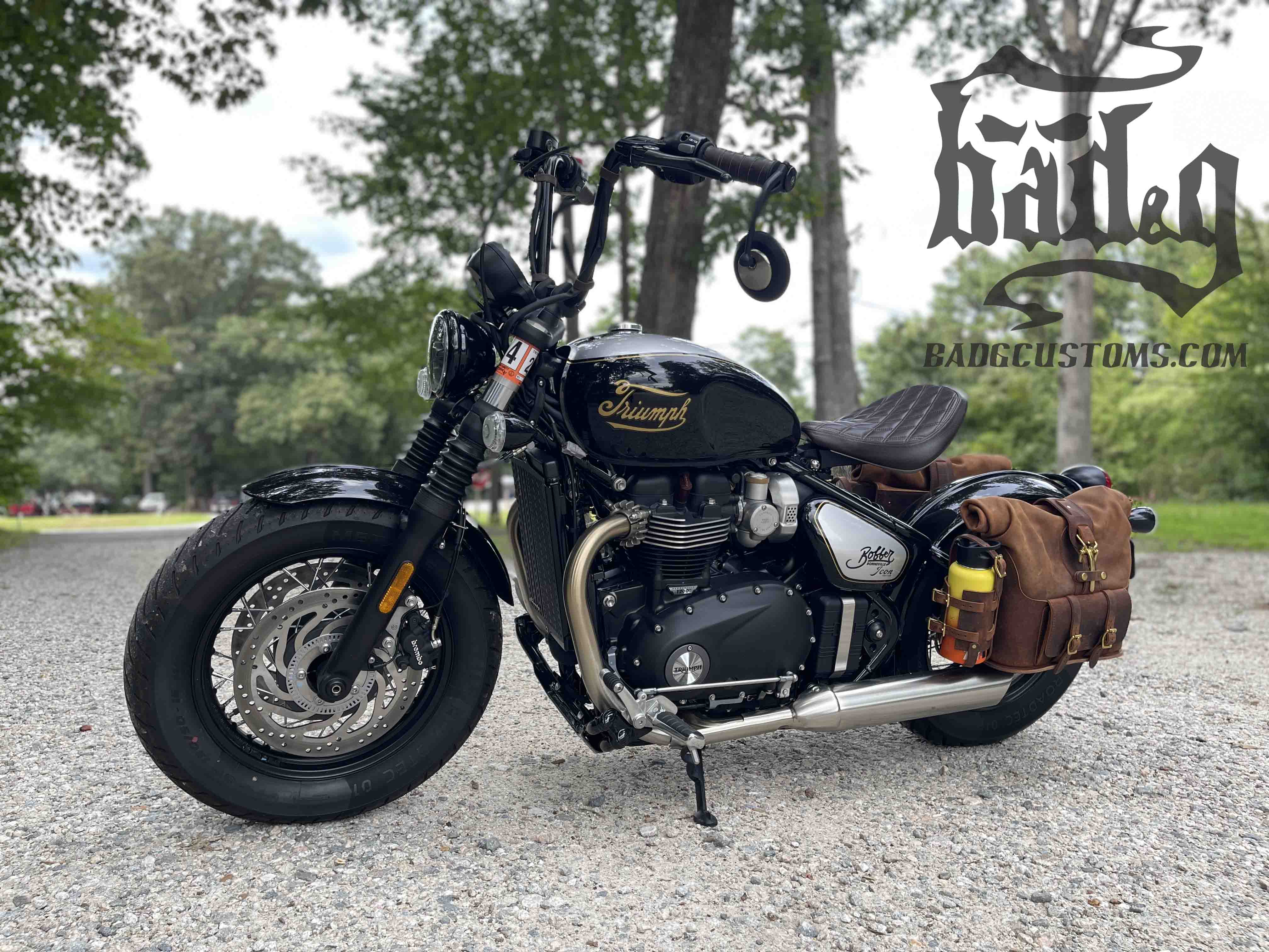 Triumph Bonneville Bobber Panniers Rolltop Swingarm Saddlebags. Hand crafted in USA with premium veg tan water buffalo leather, waterproof liners and solid brass hardware. BAD&G Customs TBP01