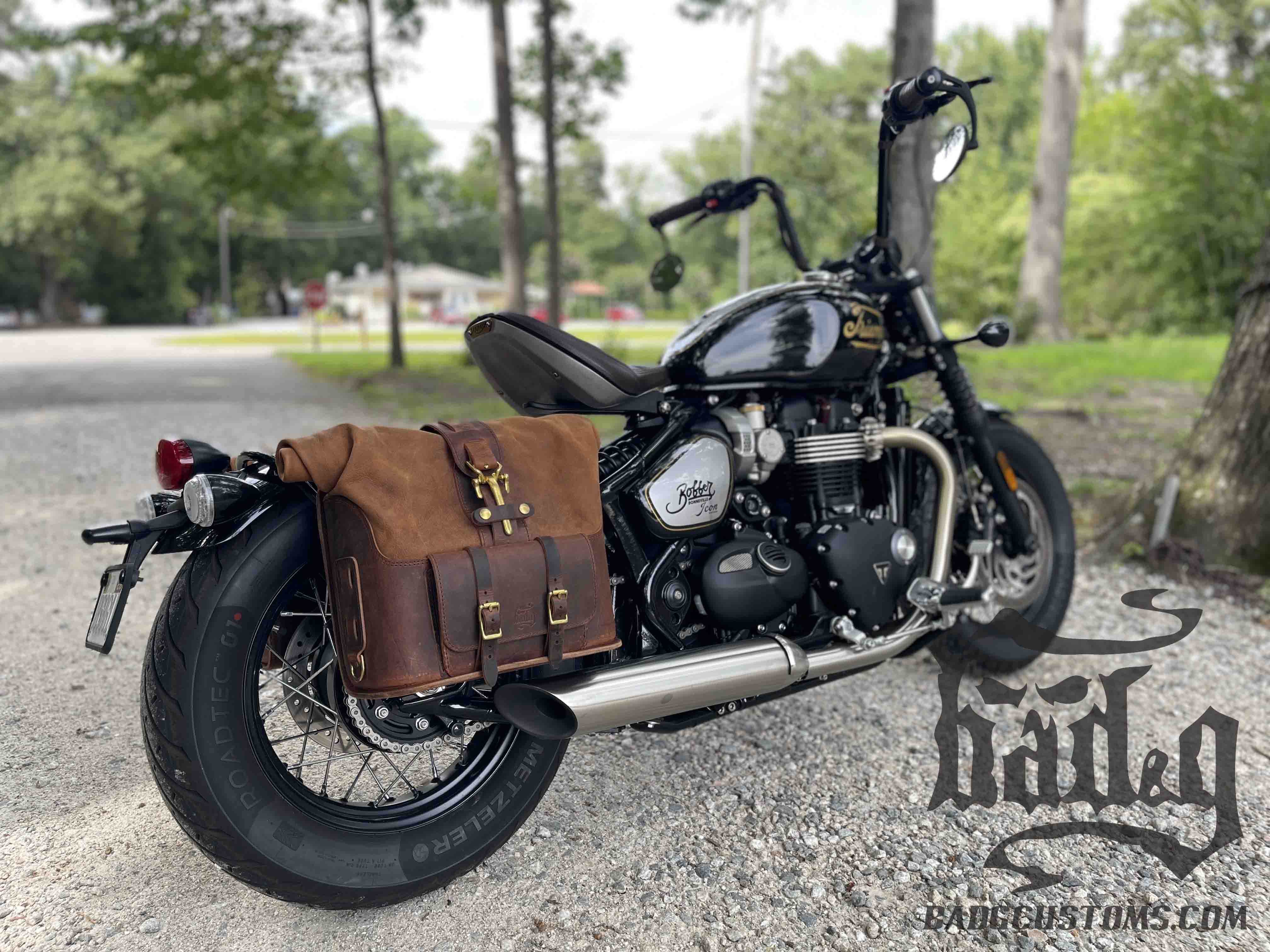 Triumph Bonneville Bobber Panniers Rolltop Swingarm Saddlebags. Hand crafted in USA with premium veg tan water buffalo leather, waterproof liners and solid brass hardware. BAD&G Customs TBP01